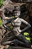 Bangkok Wat Pho, miniature mountain covered in statues of rishis (hermits) demonstrating various positions of healing massage. 